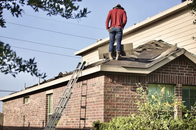Professional roofer working on a residential roof in Frisco